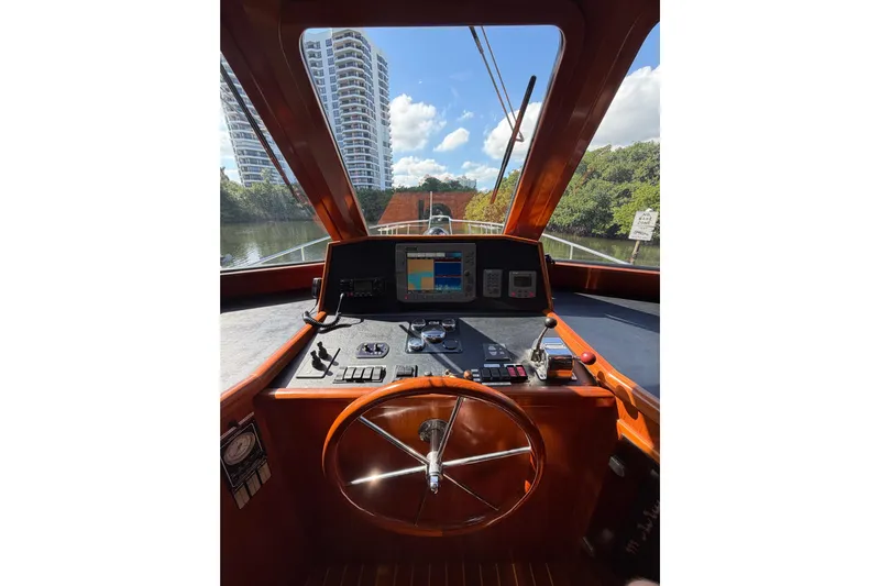 Angels Envy Yacht Photos Pics Helm of 2006 North Pacific 42 boat with cityscape view.