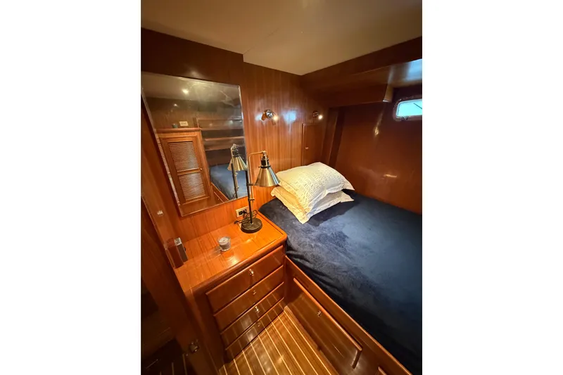Angels Envy Yacht Photos Pics Cozy cabin interior of 2006 North Pacific 42 yacht with wooden finish and comfortable bedding.