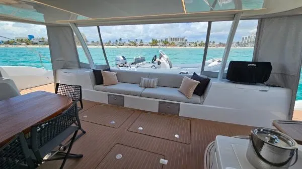 Sunlove Yacht Photos Pics Luxurious interior of 2024 Lagoon SIXTY 7 yacht with ocean view and elegant seating.