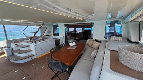 Sunlove Yacht Photos Pics Luxurious 2024 Lagoon SIXTY 7 yacht interior with elegant seating and dining area.