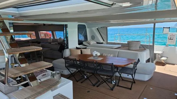 Sunlove Yacht Photos Pics Luxurious interior of 2024 Lagoon SIXTY 7 yacht with ocean view and elegant seating area.