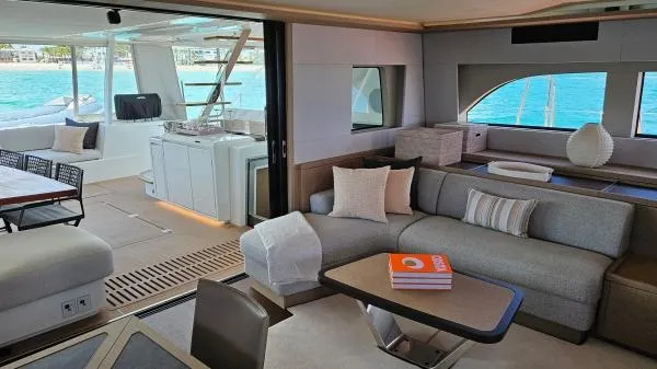 Sunlove Yacht Photos Pics Luxurious interior of 2024 Lagoon SIXTY 7 yacht with modern furnishings and ocean view.