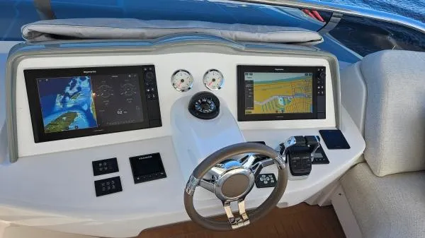 Sunlove Yacht Photos Pics 2024 Lagoon SIXTY 7 yacht helm with dual navigation screens and modern controls.