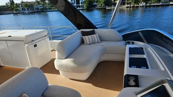 Sunlove Yacht Photos Pics Luxurious 2024 Lagoon SIXTY 7 yacht deck with plush seating and scenic water view.