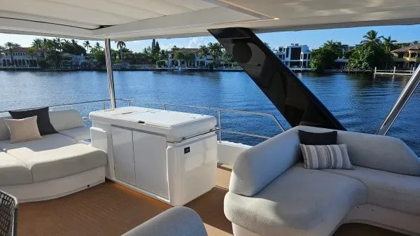 Sunlove Yacht Photos Pics Luxurious 2024 Lagoon SIXTY 7 yacht deck with elegant seating and waterfront view.