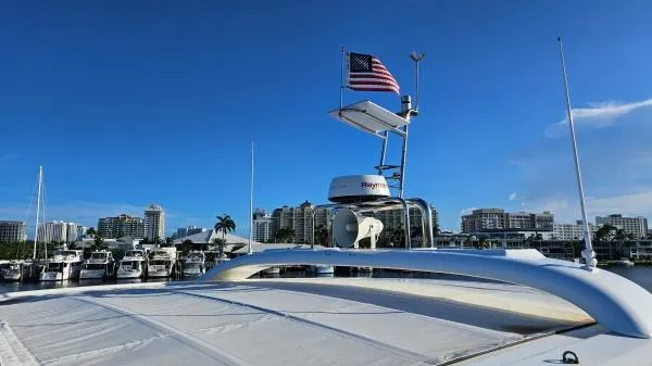 Sunlove Yacht Photos Pics 2024 Lagoon SIXTY 7 yacht docked with city skyline and American flag.