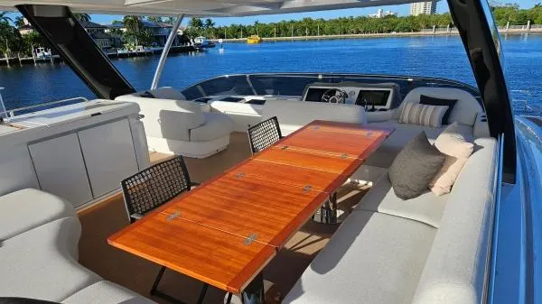 Sunlove Yacht Photos Pics Luxurious 2024 Lagoon SIXTY 7 yacht with elegant outdoor seating and dining area.