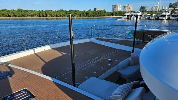 Sunlove Yacht Photos Pics 2024 Lagoon SIXTY 7 yacht deck with scenic waterfront view.