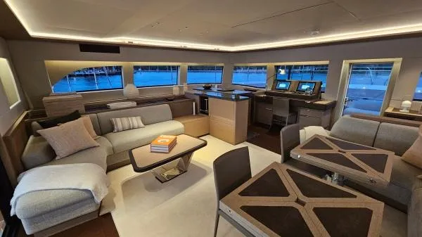 Sunlove Yacht Photos Pics Luxurious interior of 2024 Lagoon SIXTY 7 yacht with modern furnishings and panoramic windows.