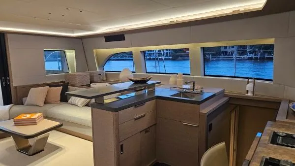 Sunlove Yacht Photos Pics Luxurious interior of 2024 Lagoon SIXTY 7 yacht with modern kitchen and seating area.