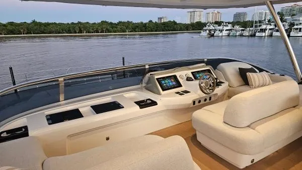 Sunlove Yacht Photos Pics Luxurious 2024 Lagoon SIXTY 7 yacht interior with modern helm and plush seating by the water.