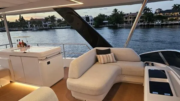 Sunlove Yacht Photos Pics Luxurious 2024 Lagoon SIXTY 7 yacht interior with elegant seating and scenic waterfront view.