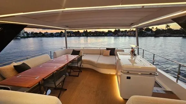 Sunlove Yacht Photos Pics Luxurious 2024 Lagoon SIXTY 7 yacht interior with elegant seating and sunset view.