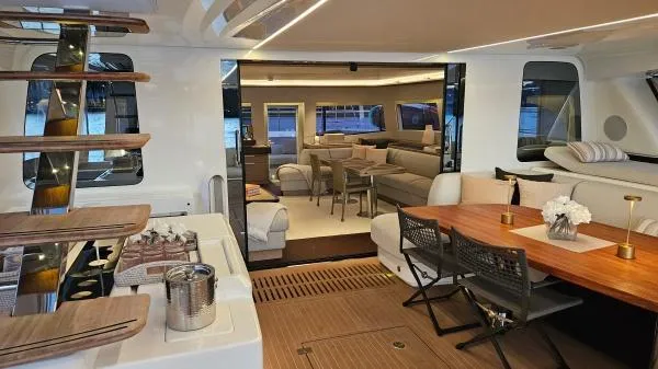 Sunlove Yacht Photos Pics Luxurious interior of 2024 Lagoon SIXTY 7 yacht with elegant seating and dining area.