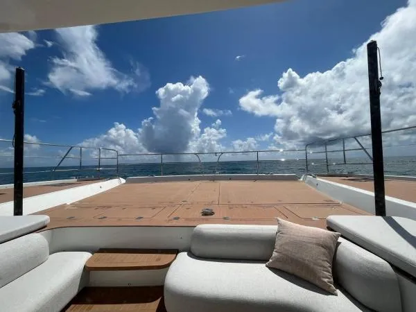 Sunlove Yacht Photos Pics 2024 Lagoon SIXTY 7 yacht deck with ocean view and blue sky.
