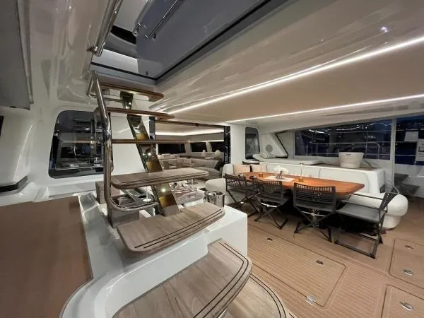 Sunlove Yacht Photos Pics Luxurious interior of 2024 Lagoon SIXTY 7 yacht with elegant seating and modern staircase.
