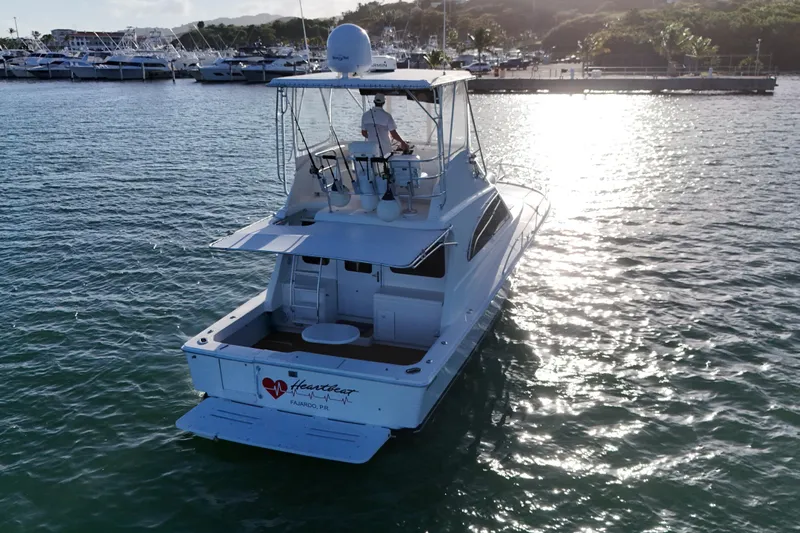  Yacht Photos Pics 2005 Luhrs 38 Convertible yacht cruising in sunny marina waters.