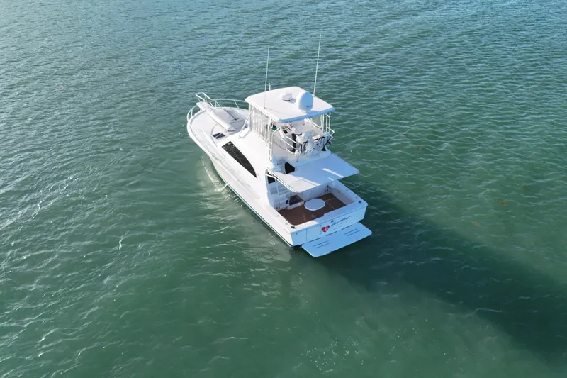  Yacht Photos Pics 2005 Luhrs 38 Convertible yacht cruising on open water.