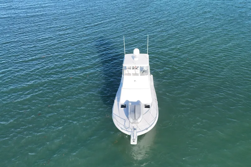  Yacht Photos Pics 2005 Luhrs 38 Convertible boat on calm blue water, aerial view.