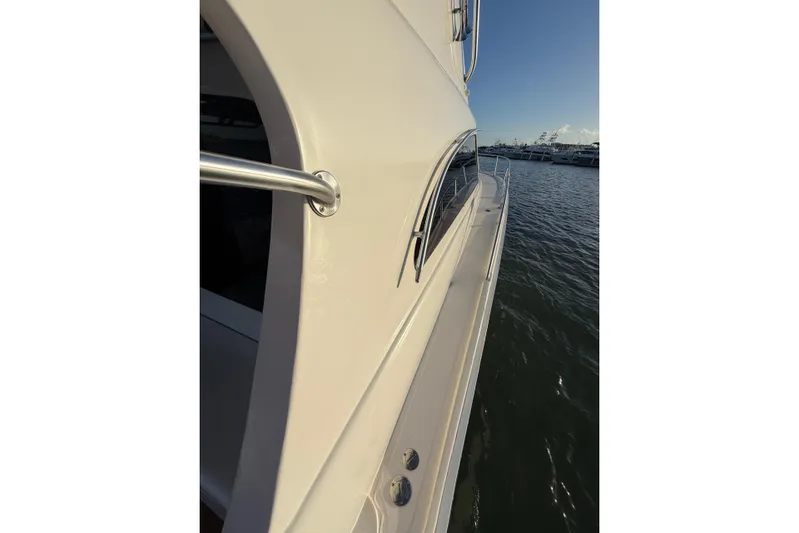  Yacht Photos Pics 2005 Luhrs 38 Convertible yacht side view on water.