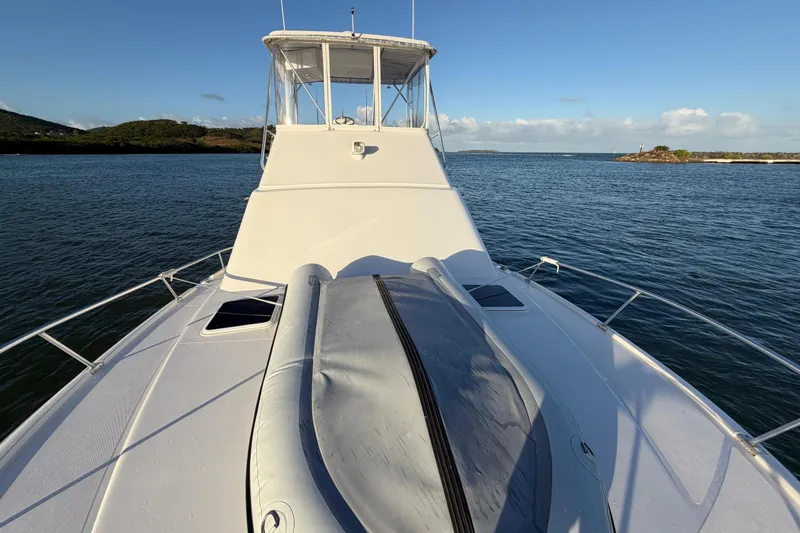  Yacht Photos Pics 2005 Luhrs 38 Convertible yacht on calm waters, clear sky, scenic view.