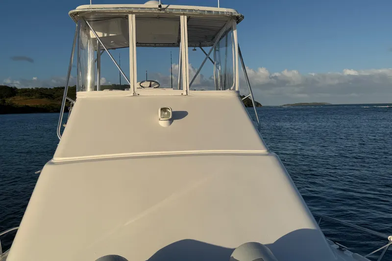  Yacht Photos Pics 2005 Luhrs 38 Convertible boat on calm water, clear sky background.