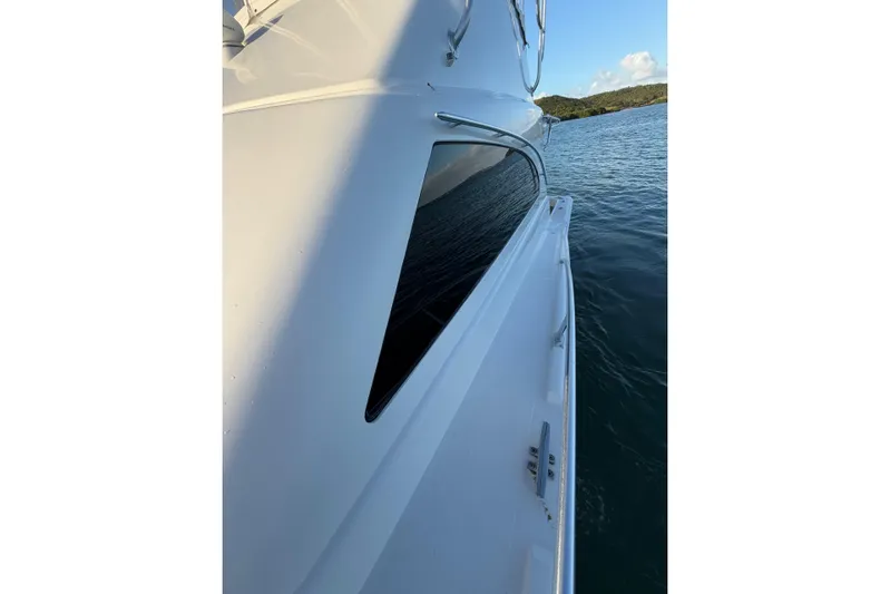  Yacht Photos Pics 2005 Luhrs 38 Convertible yacht side view on calm water.