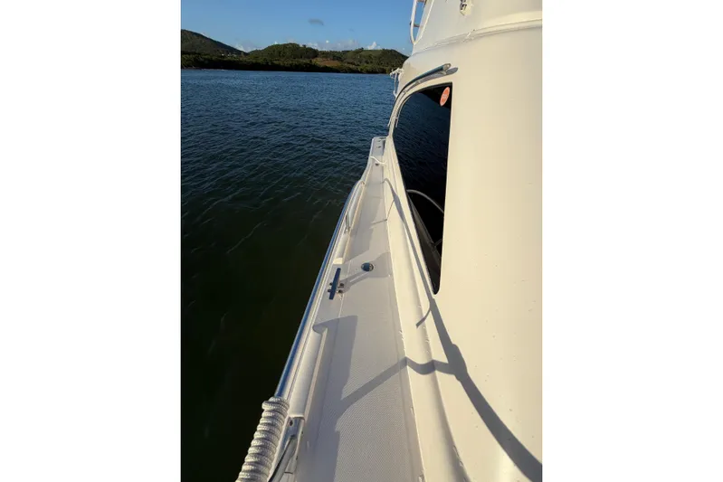  Yacht Photos Pics 2005 Luhrs 38 Convertible yacht on calm water, side view with clear skies.