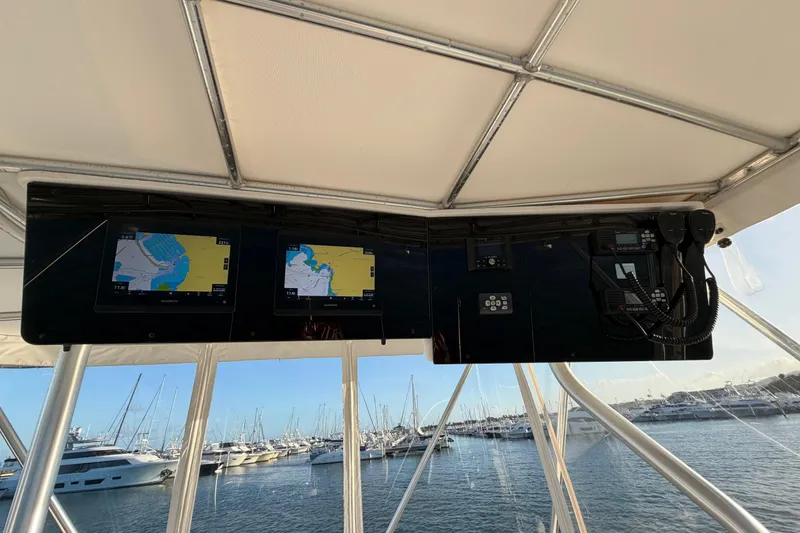  Yacht Photos Pics 2005 Luhrs 38 Convertible yacht helm with navigation screens and marina view.