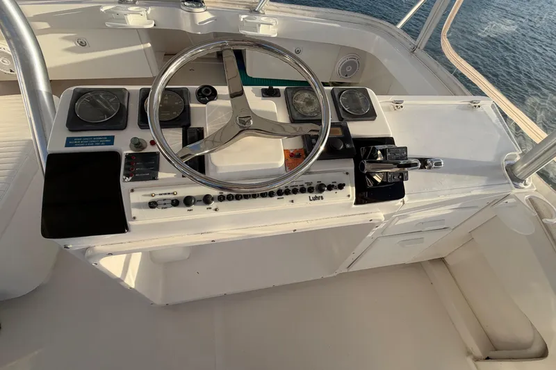  Yacht Photos Pics 2005 Luhrs 38 Convertible boat helm with steering wheel and control panel.