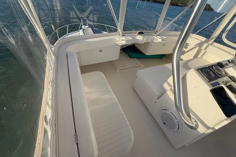  Yacht Photos Pics 2005 Luhrs 38 Convertible boat interior with seating and control panel, on calm water.