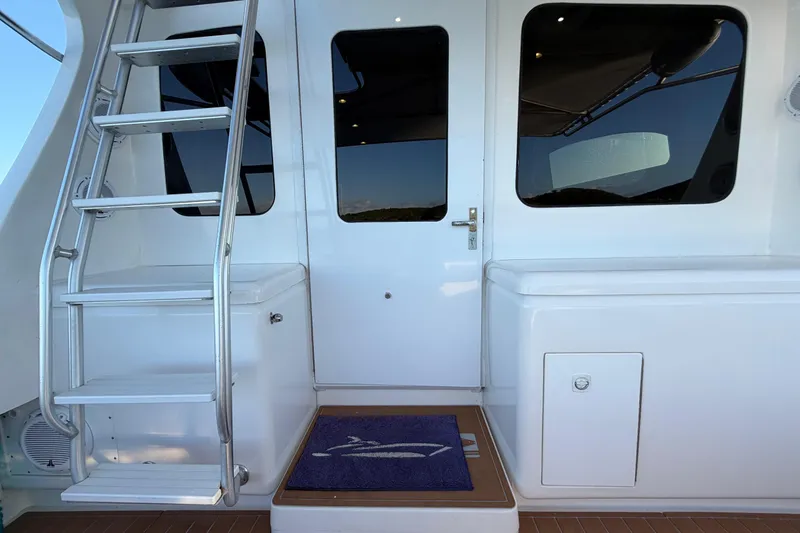  Yacht Photos Pics 2005 Luhrs 38 Convertible yacht with ladder and door, featuring sleek white design.