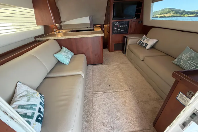  Yacht Photos Pics Interior of 2005 Luhrs 38 Convertible yacht with beige sofas and nautical decor.