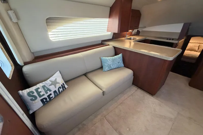  Yacht Photos Pics Interior of 2005 Luhrs 38 Convertible yacht with beige sofa and decorative pillows.