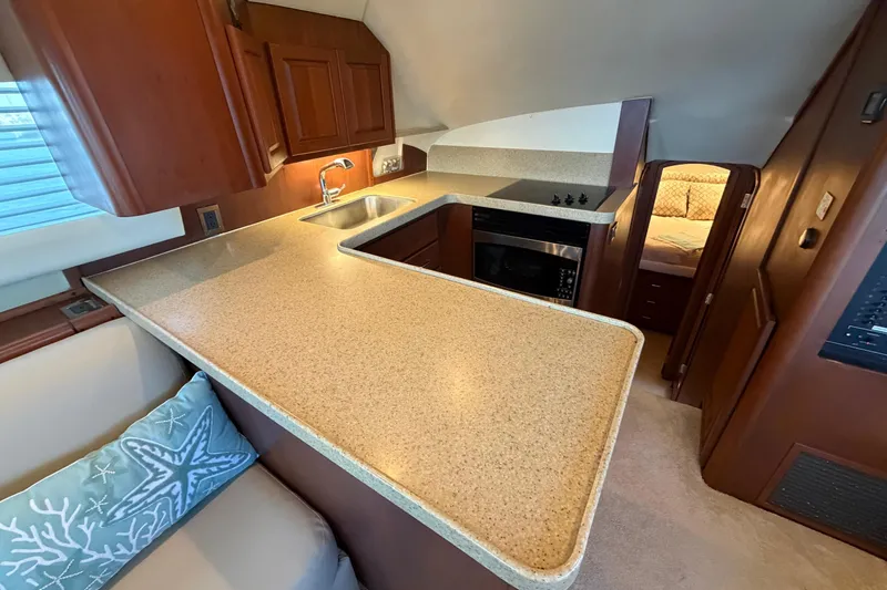  Yacht Photos Pics 2005 Luhrs 38 Convertible yacht interior with modern kitchen and cozy cabin.