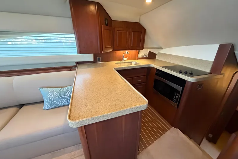  Yacht Photos Pics 2005 Luhrs 38 Convertible yacht interior with modern kitchen and cozy seating area.