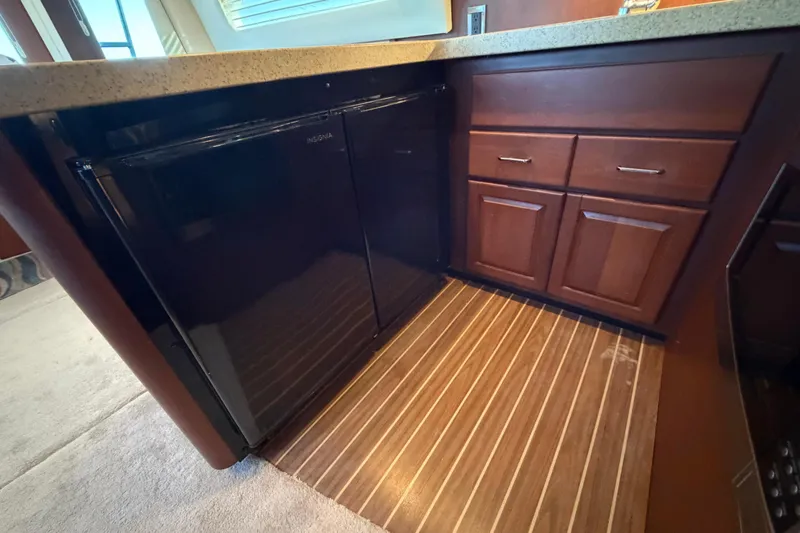  Yacht Photos Pics 2005 Luhrs 38 Convertible yacht interior with wood cabinetry and Insignia refrigerator.
