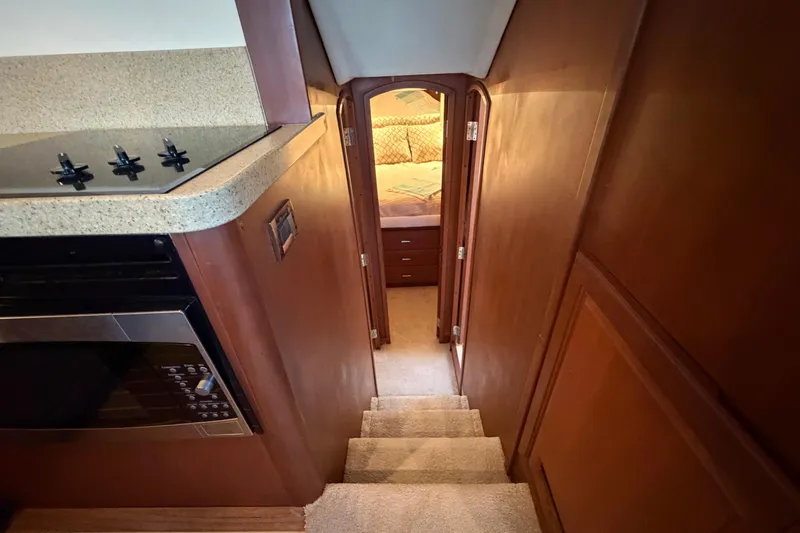  Yacht Photos Pics Interior of 2005 Luhrs 38 Convertible yacht, featuring stairs and cozy bedroom.