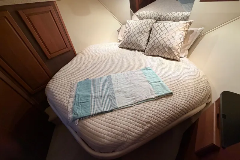  Yacht Photos Pics Cozy bedroom in 2005 Luhrs 38 Convertible yacht with plush bedding and pillows.