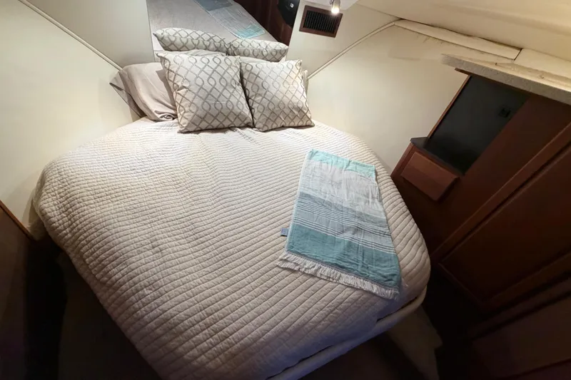  Yacht Photos Pics Cozy bedroom in 2005 Luhrs 38 Convertible yacht with quilted bedding and pillows.