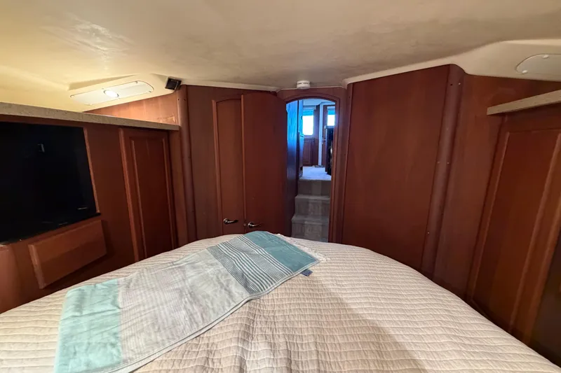  Yacht Photos Pics 2005 Luhrs 38 Convertible cabin interior with wood paneling and bed.