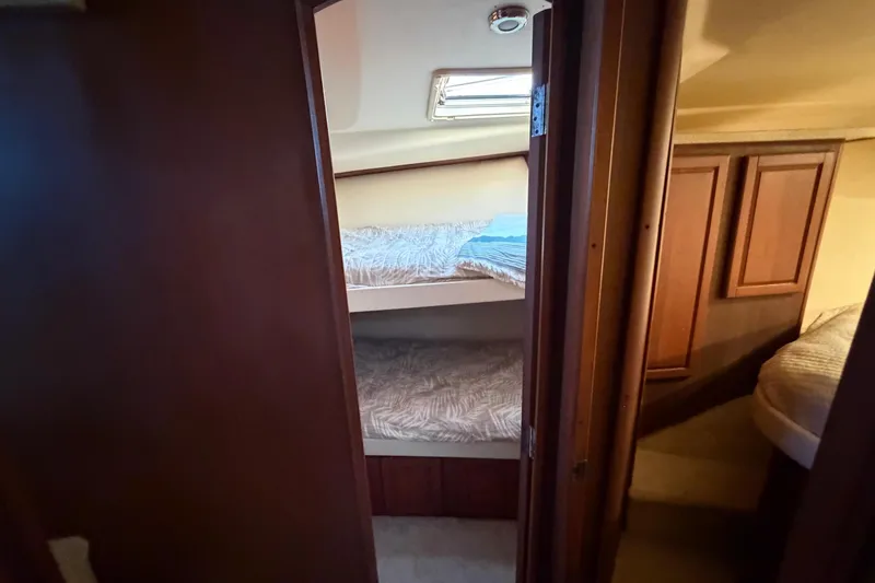  Yacht Photos Pics 2005 Luhrs 38 Convertible interior with bunk beds and wooden cabinetry.