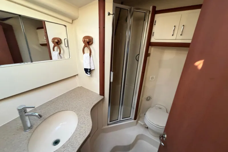  Yacht Photos Pics 2005 Luhrs 38 Convertible yacht bathroom with shower, sink, and toilet.