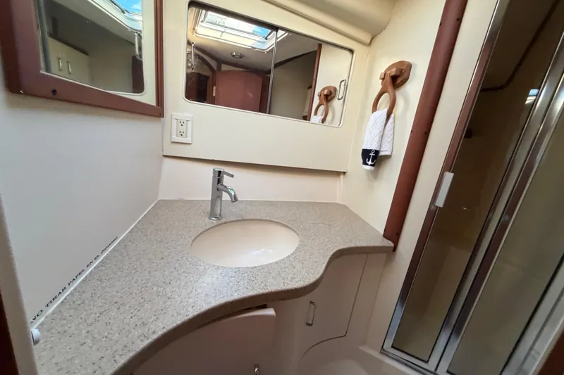  Yacht Photos Pics Bathroom interior of 2005 Luhrs 38 Convertible yacht with modern sink and mirror.