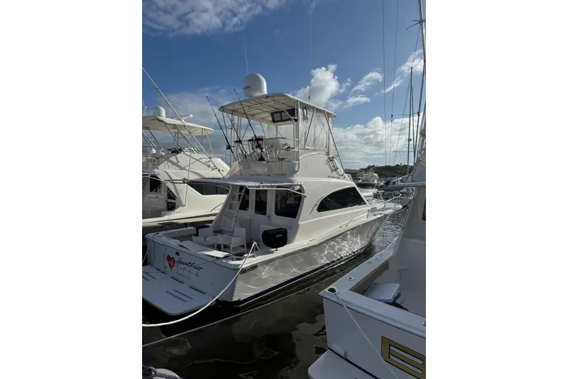  Yacht Photos Pics 2005 Luhrs 38 Convertible yacht docked at marina under clear blue sky.