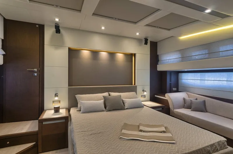  Yacht Photos Pics Luxurious bedroom interior on a 2016 Prestige 750 yacht, featuring modern design and ambient lighting.