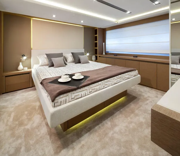  Yacht Photos Pics Luxurious bedroom interior on a 2016 Prestige 750 yacht, featuring modern design and elegant decor.