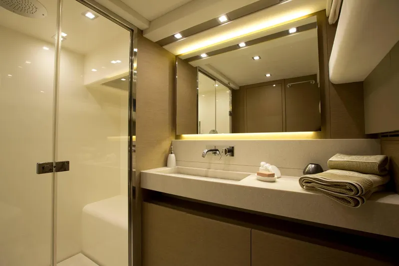  Yacht Photos Pics Luxurious bathroom interior of 2016 Prestige 750 yacht with modern fixtures and elegant lighting.
