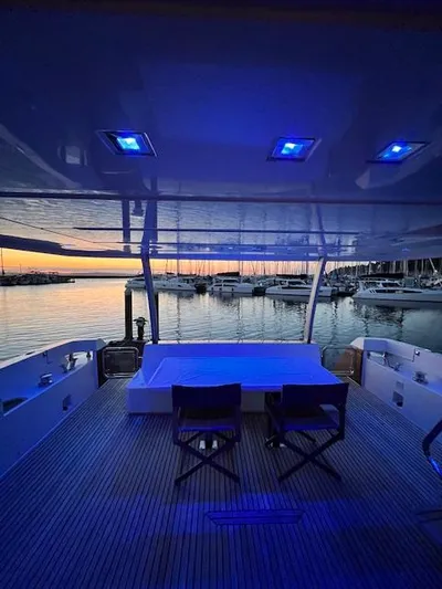  Yacht Photos Pics Prestige 750 yacht interior with blue lighting, overlooking marina at sunset, 2016 model.