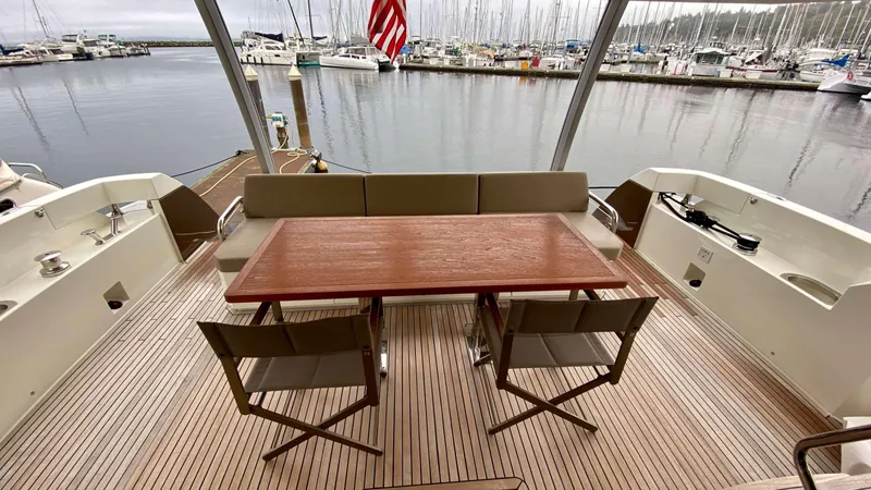  Yacht Photos Pics Prestige 750 yacht deck with wooden table and chairs, marina view, 2016 model.